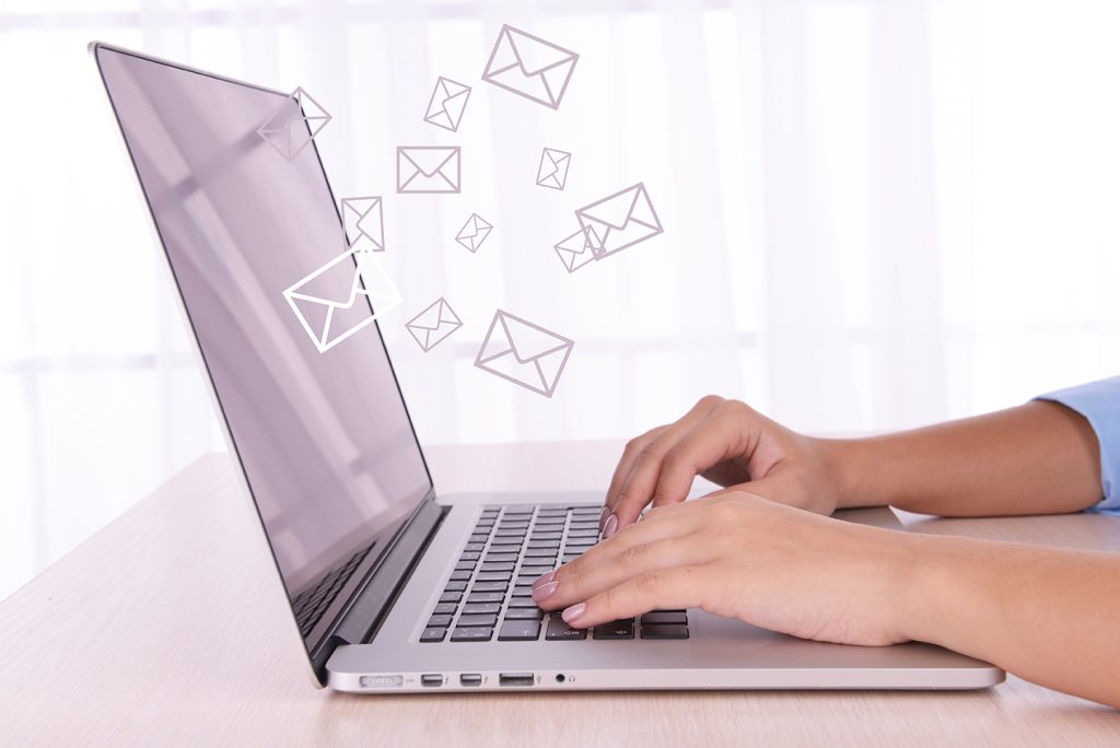 Email concept with laptop and hands
